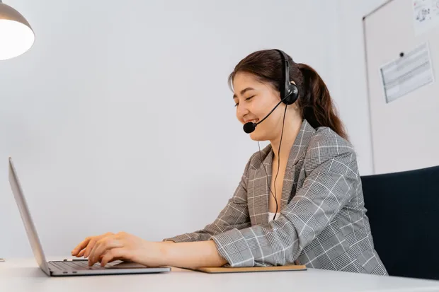 A dental administrator working remotely at a desk