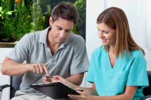 man paying for dental services